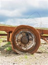 rusty old car wheel no tyre rim still attached to the vehicle