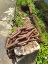 Rusty old chain in the road edge