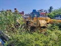 Rusty old digger in a waste area field. Repaired Bulldozer, heavy machinery, focus on arm and bucket Royalty Free Stock Photo