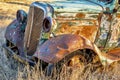 Rusty old forgotten truck in a wheat field