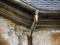 Rusty old gutter in front of an old facade Royalty Free Stock Photo