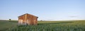 rusty old iron barn in belgian countryside with grass and corn field Royalty Free Stock Photo