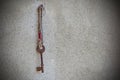 Rusty old key hanged on a nail Royalty Free Stock Photo