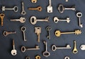 Rusty old keys locks - on dark wooden rustic background