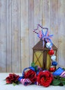 A rusty old lantern decorated with red, white and blue USA patriotic stars and stripes ribbons