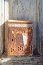 Rusty old mailbox on a time damaged door