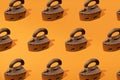 Rusty old metal steam iron on orange background. Minimal design and pattern Royalty Free Stock Photo