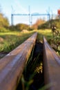 Heavy rusted iron railroad leading to an iron gate with tripwire Royalty Free Stock Photo