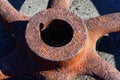 A rusty, old, round wheel hub is lit by the sunlight Royalty Free Stock Photo