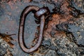 Old rusty tiedown ring set in stone Royalty Free Stock Photo