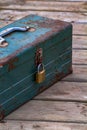 Rusty old toolbox locked up sitting on a wood Royalty Free Stock Photo