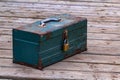 Rusty old toolbox locked up sitting on a wood Royalty Free Stock Photo