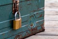 Rusty old toolbox locked up sitting on a wood