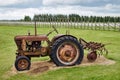 Rusty old tractor standing on the field Royalty Free Stock Photo