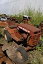 Rusty old Wheel Horse garden tractor in a junkyard