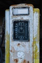 A rusty old yellow petrol pump