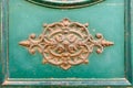 rusty ornamental decoration at a green door in Italy