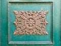 rusty ornamental decoration at a green door in Italy