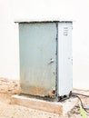 Rusty outdoor weather proof electrical cabinet mounted on a concrete base. Royalty Free Stock Photo