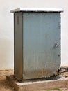Rusty outdoor weather proof electrical cabinet mounted on a concrete base. Royalty Free Stock Photo