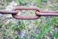 Rusty oxidized brown old ancient vintage strong forged metal iron chain with connected links against the background Royalty Free Stock Photo