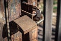 Rusty padlock hanging on a gate outdoors. Locked gates, locked doors, closed area Royalty Free Stock Photo