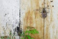 A rusty padlock hangs on the metal doors of an abandoned garage or warehouse. Storage of old things Royalty Free Stock Photo