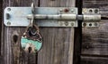 Rusty padlock and latch on old wooden door Royalty Free Stock Photo