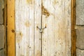 Rusty padlock locking old wooden door with a chain Royalty Free Stock Photo