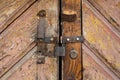 Rusty padlock locking a wooden door