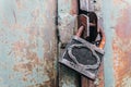 Rusty padlock locks the old gate of an abandoned hangar Royalty Free Stock Photo