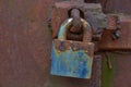 Rusty padlock on a rusty door