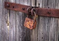 Rusty padlock on old vintage wooden door Royalty Free Stock Photo