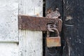 Rusty padlock on an old wooden door. Royalty Free Stock Photo