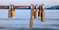 Rusty padlocks has been locked on a peeled railing. Blur background, close up view with details.