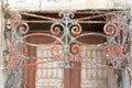 Rusty painted old ornate decorative wrought iron grill in front of door Royalty Free Stock Photo