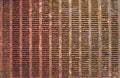 Rusty perforated metal sheet close-up. Iron surface with many holes Royalty Free Stock Photo