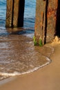 Rusty pier pillars overgrown with algae on the Baltic Sea Royalty Free Stock Photo