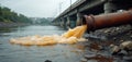 Rusty pipeline discharges brown polluted water into a river. Cloudy sky above. Bridge with columns in background. Water Royalty Free Stock Photo