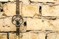 Rusty pipeline valve on brick wall background Royalty Free Stock Photo