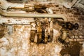 Rusty pipes on old antique wall, destroyed layer of concrete wall plaster, dark grunge abstract background Royalty Free Stock Photo