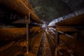 Rusty pipes of the pipeline of the heating main in round technical tunnel Royalty Free Stock Photo