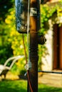 Rusty pole with wiring in countryside house