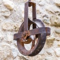 Rusty pull chain attached to an aged stone wall in an outdoor setting Royalty Free Stock Photo