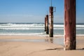 Rusty pylons on the beach