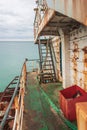 Rusty railing, boards and ladders of the shipwrecked ship. View from the ship.