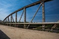 Rusty railings on the bridge. Road with cracked asphalt Royalty Free Stock Photo