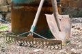 A rusty rake and a shovel for agricultural or gardening works