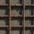 Rusty rebar grid on concrete surface under sunlight. Royalty Free Stock Photo