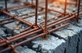 Rusty rebar grid reinforcing concrete foundation. Close up of construction site. Metal framework for structural support.